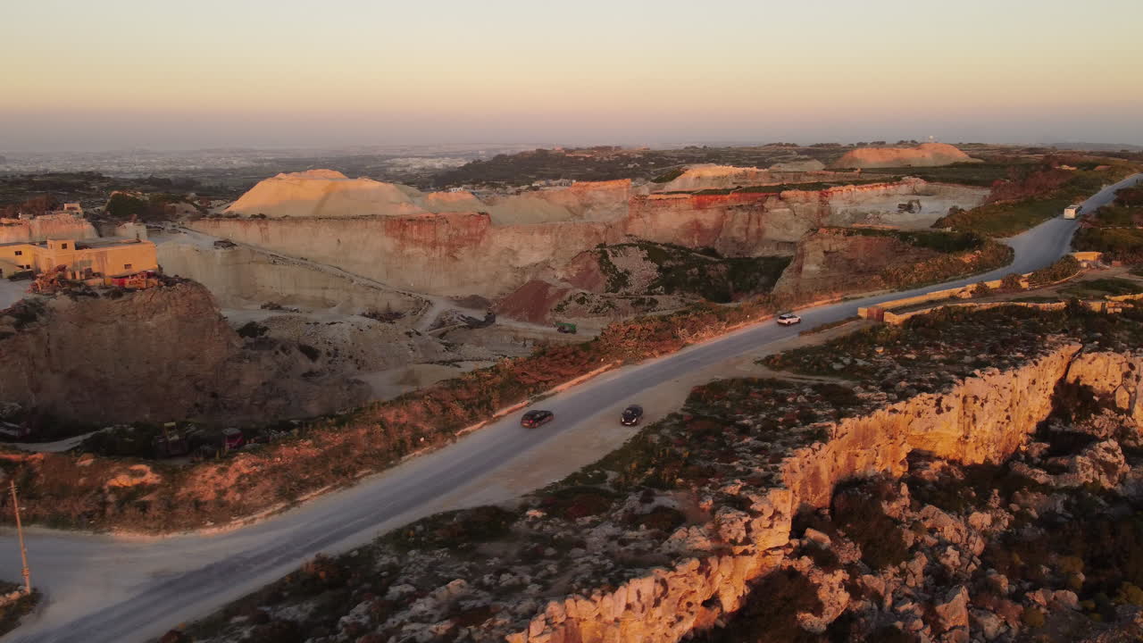 바위 옆에서 suv의 일몰 드론 샷