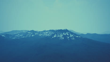 awesome top view through clouds to high snowy mountains