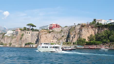 ship sailing past cliffs in sorrento, italy