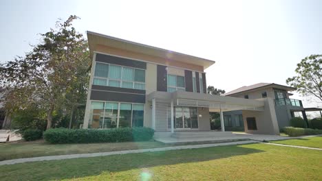 modern two-story house with lush landscaping