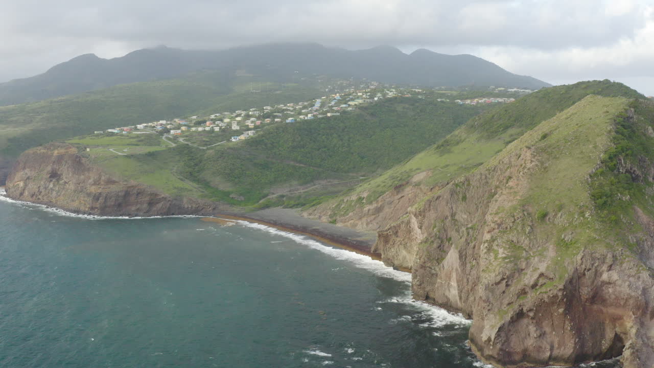 Abandoned Caribbean beach, dawn. Smooth fly in, towards a large landmass surrounded by water. A small town is visible along with large distant mountains surrounded by rain clouds.
4K UHD at 23.98 fps.