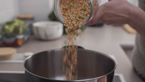 woman pouring grains into a bowl for cooking