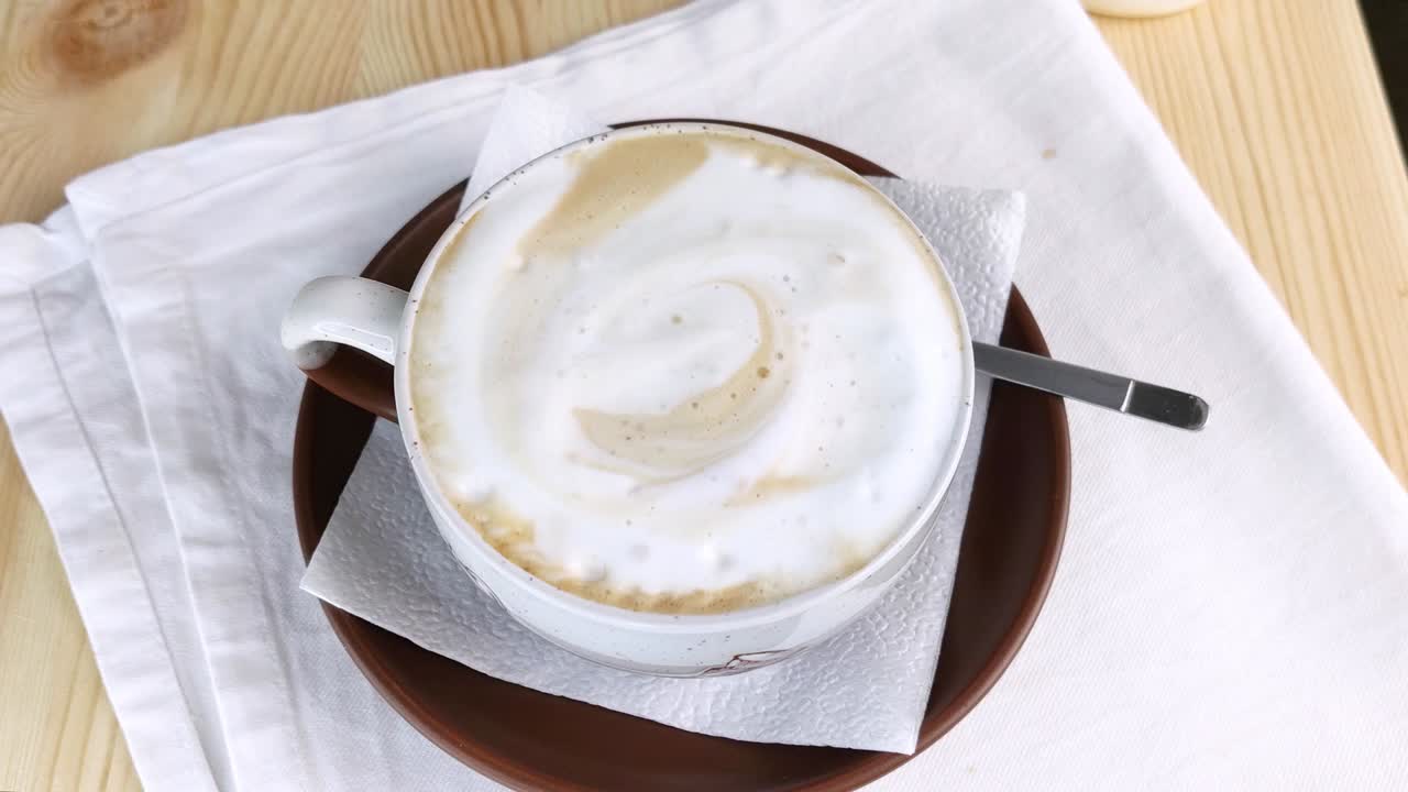 Cappuccino or latte. Coffee with froth milk in round cup