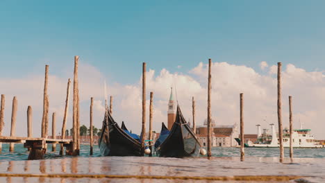 waves break by venetian gondolas