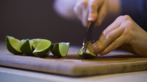 cutting limes on a wooden chopping board