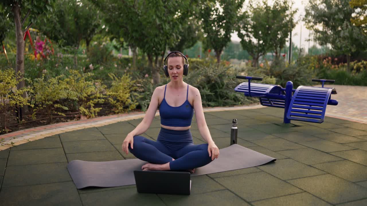 mujer practicando yoga en línea en un parque