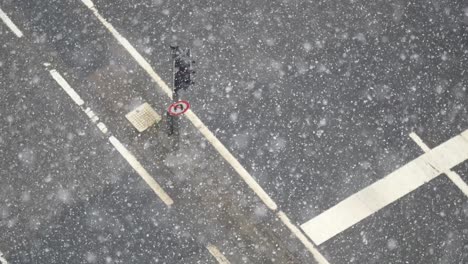 snowy intersection with pedestrian