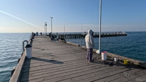 person fishing on a pier in melbourne