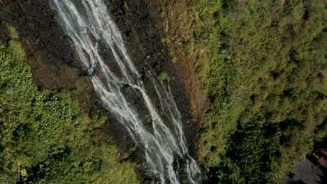 drone ascends through cascada de la virgen in banos city, ecuador