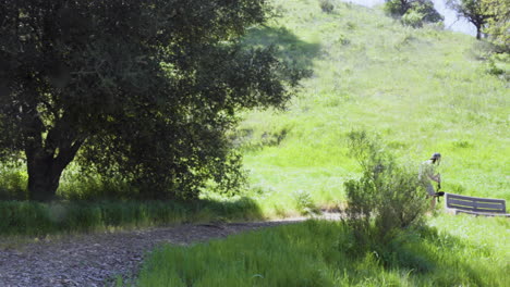 Usando-Gimbal,-Un-Cineasta-Adolescente-Camina-Con-Cuidado-Mientras-Filma-El-Paisaje-En-El-Parque