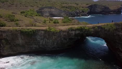 amazing aerial view flight fly forwards drone shot to natural bridge at
broken beach at nusa penida in bali