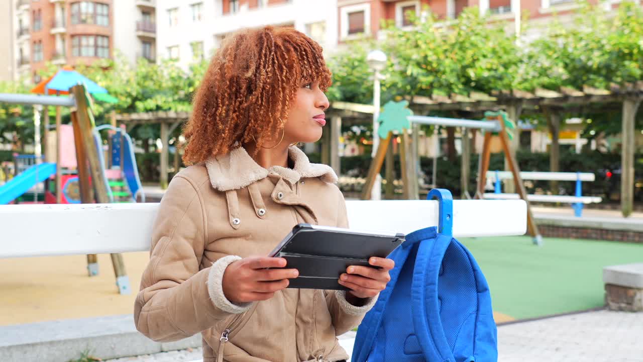 Woman with Tablet in Urban Park