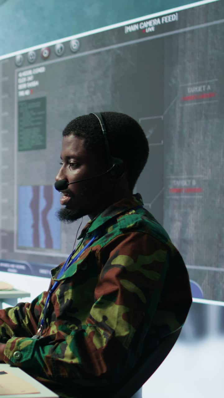 Vertical Video Army professional in uniform works in a mission control center