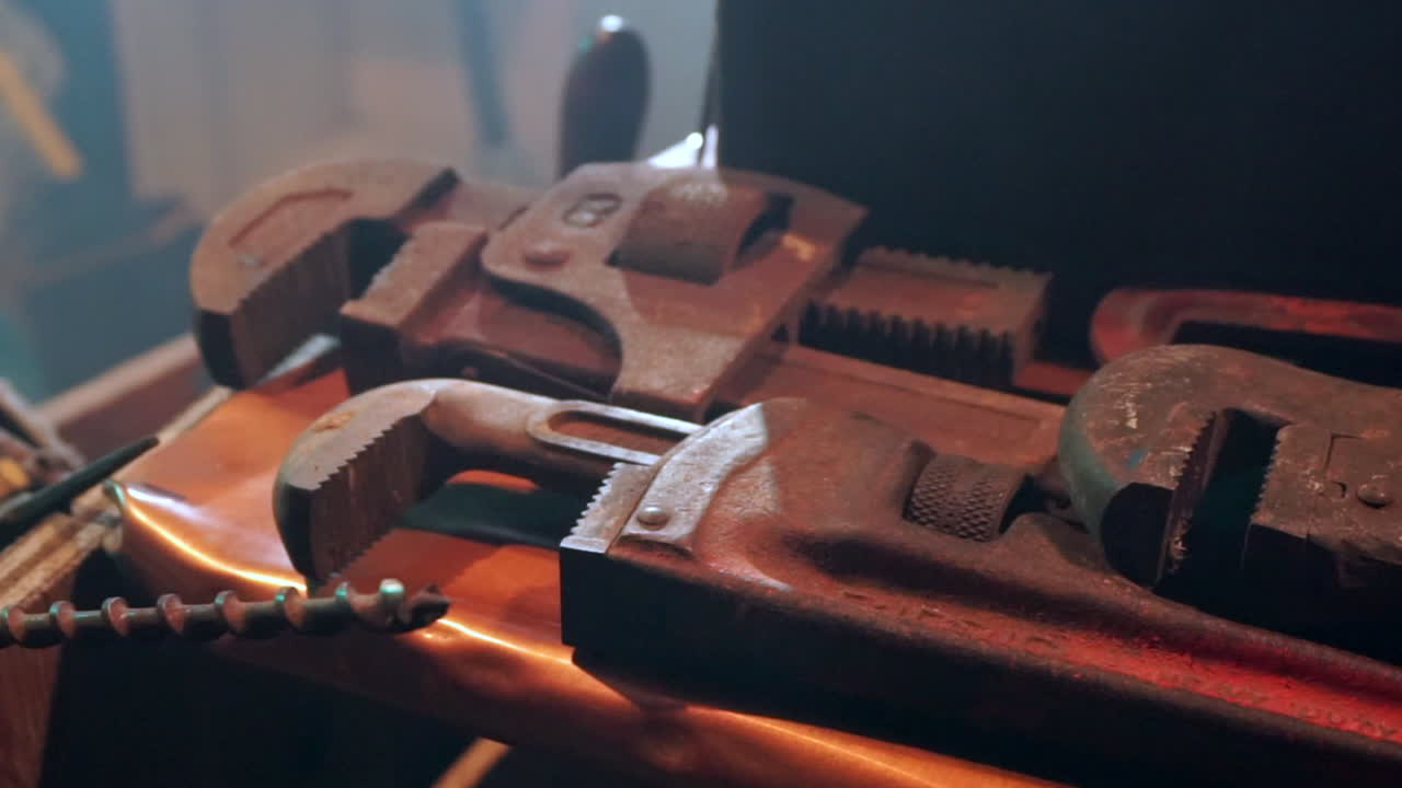 Large pipe wrenches on a workbench. Zoom to close up