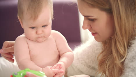 mother playing with baby