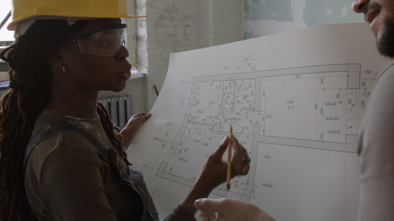 Construction workers reviewing blueprints