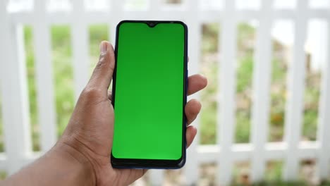 Rear-view-of-young-man-using-smart-phone-at-outdoor