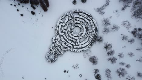 View-of-a-labyrinth-as-people-walk-around-in-winter