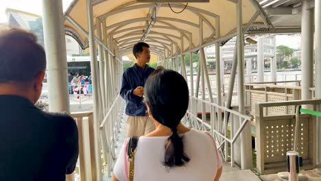 passengers walking on a ferry boarding ramp