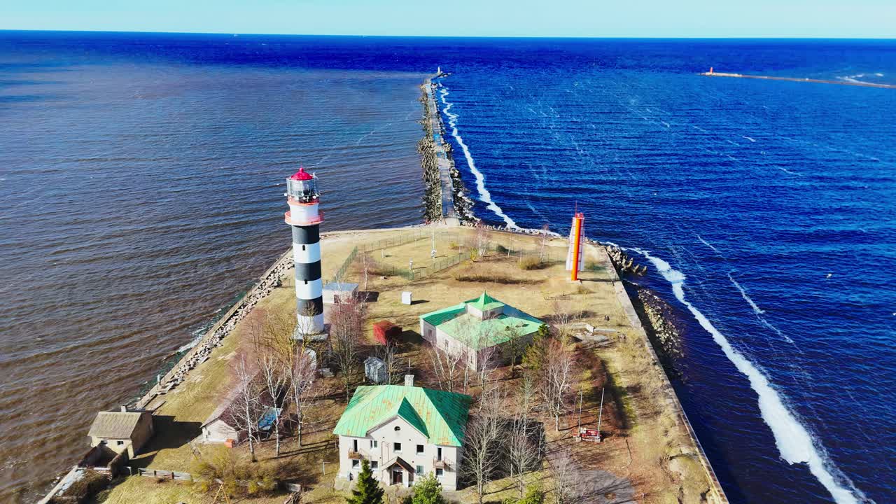 Drone view over a striped lighthouse in Mangaļsala, Latvia