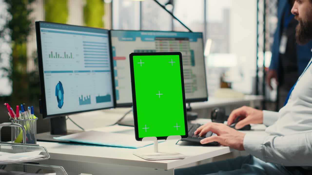 Vertical Video Business consultant examining forecasts with chroma key on tablet