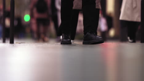 slow motion footage of black shoes walking on the sidewalk in paris, france