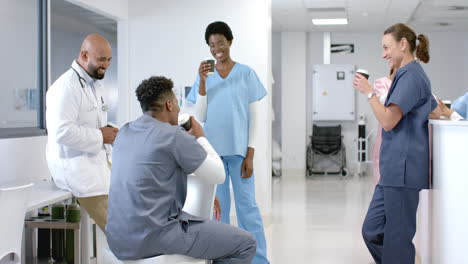 diverse healthcare professionals share a light moment in a hospital