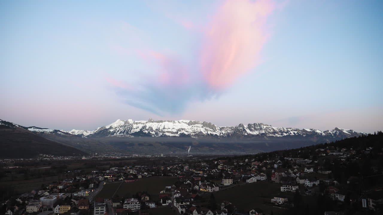 vaduz liechtenstein hermosa vista aérea con montañas nevadas en el fondo con nubes rosadas sobre ellas