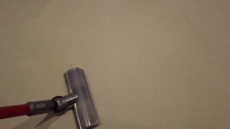 handheld vacuum cleaner moving back and forth on a carpet