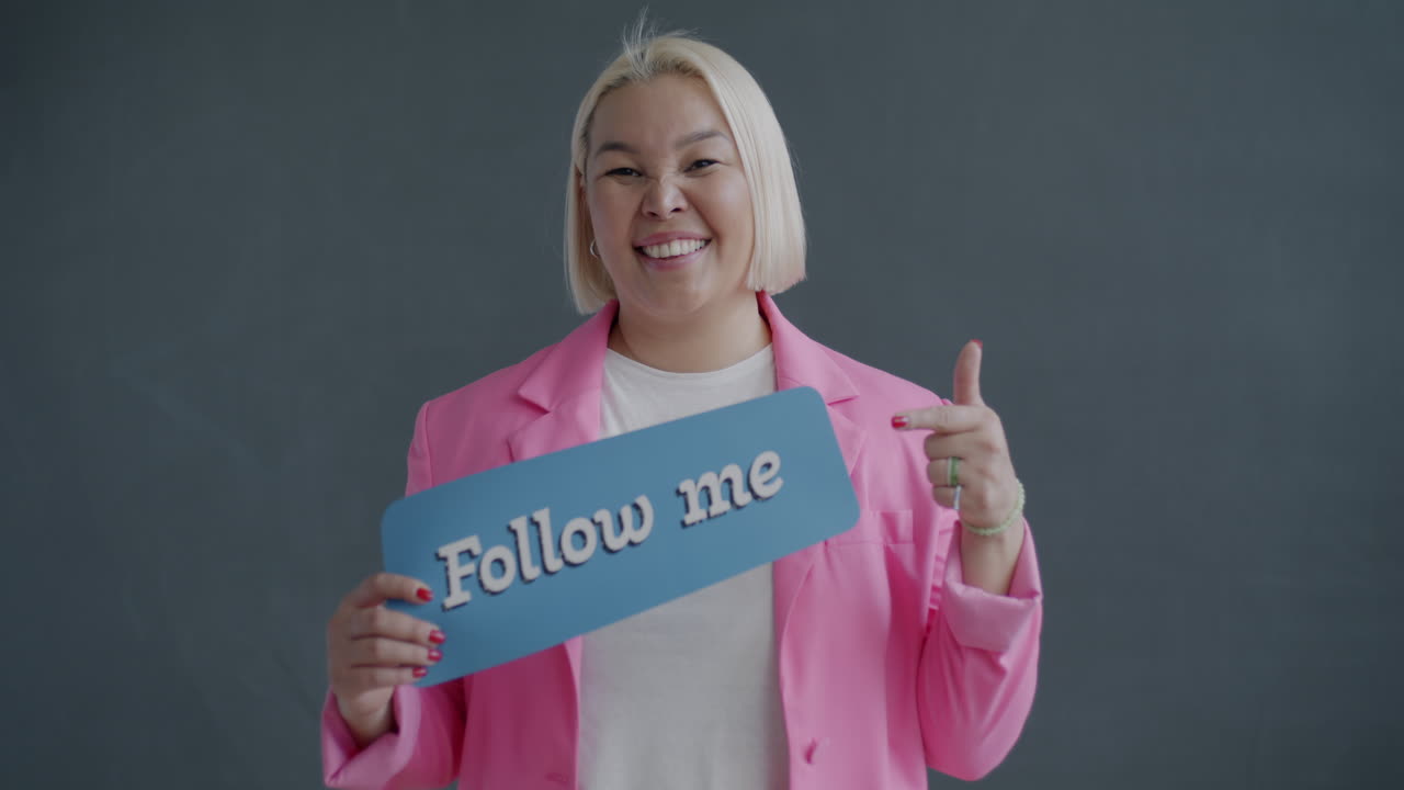 Woman Holding a "Follow Me" Sign