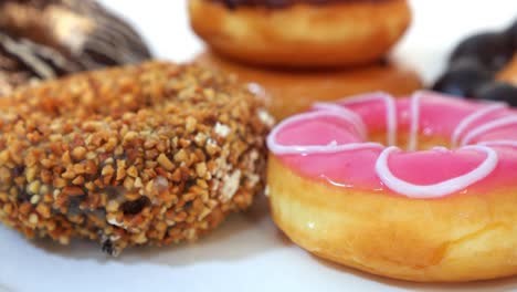 group of tasty sweet different colored donuts on white background.