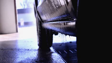 using the wand sprayer at a car wash to clean off the door and bottom section of a jeep commander