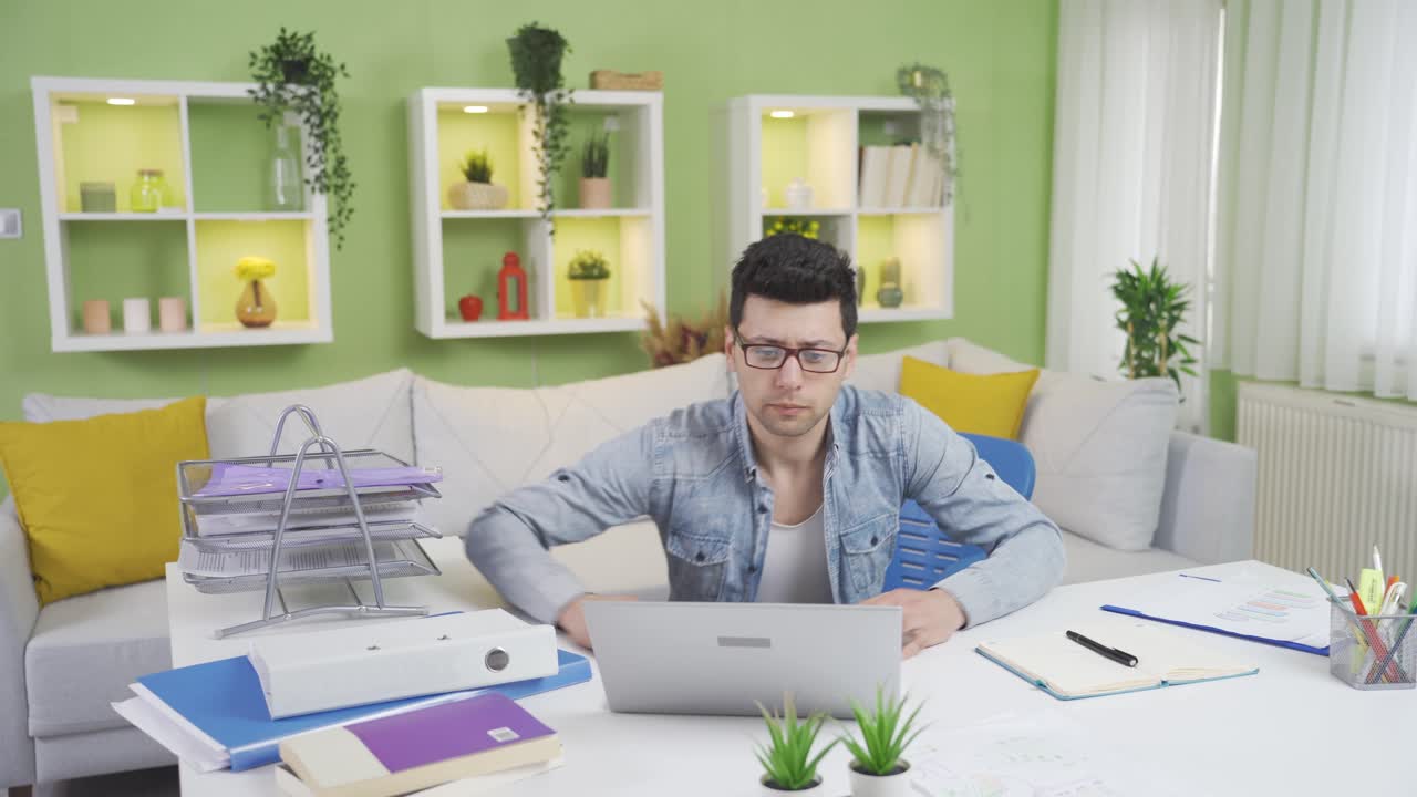 어색한 남자가 의자에 앉아서 바닥에 떨어집니다. 불행한 홈 오피스 직원.