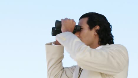 Elegant-businessman-looking-through-binoculars