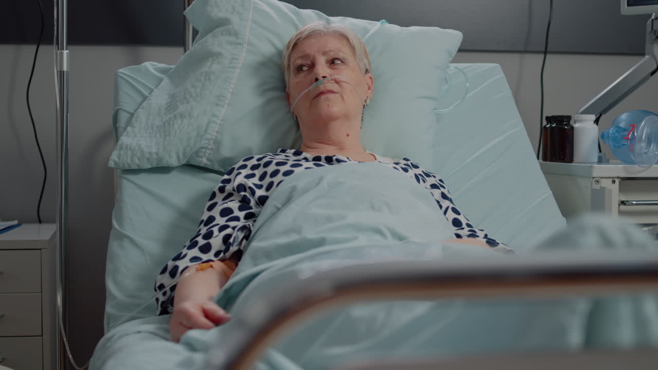 Woman with sickness receiving medication with IV drip bag