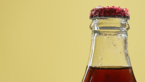 Close-Up-Of-Condensation-Droplets-On-Neck-Of-Revolving-Bottle-Of-Cold-Beer-Or-Soft-Drink-With-Metal-Cap