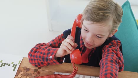 boy as business executive talking on phone 4k