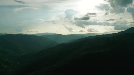 4k cinematic nature aerial footage of a drone flying over the beautiful mountains of chiang mai, thailand on a sunny day