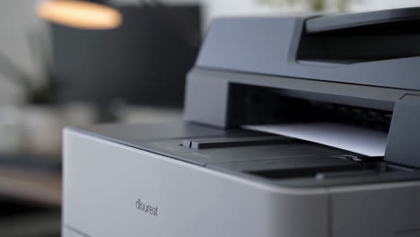 close-up of a printer with paper in an office setting