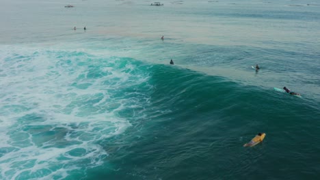 surfing at sunset at the surf spot don don in gerupuk, lombok