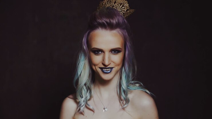 Scatto in studio colorato di una modella divertente. Ritratto di donna bellissima con trucco e capelli colorati.