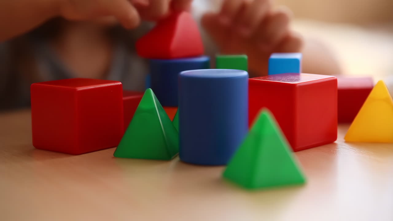 Child Playing with Colorful Geometric Building Blocks