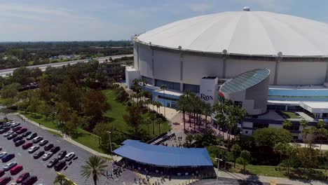 4k aerial drone video of fans filing in to tropicana field for tampa bay rays mlb playoff game in downtown st