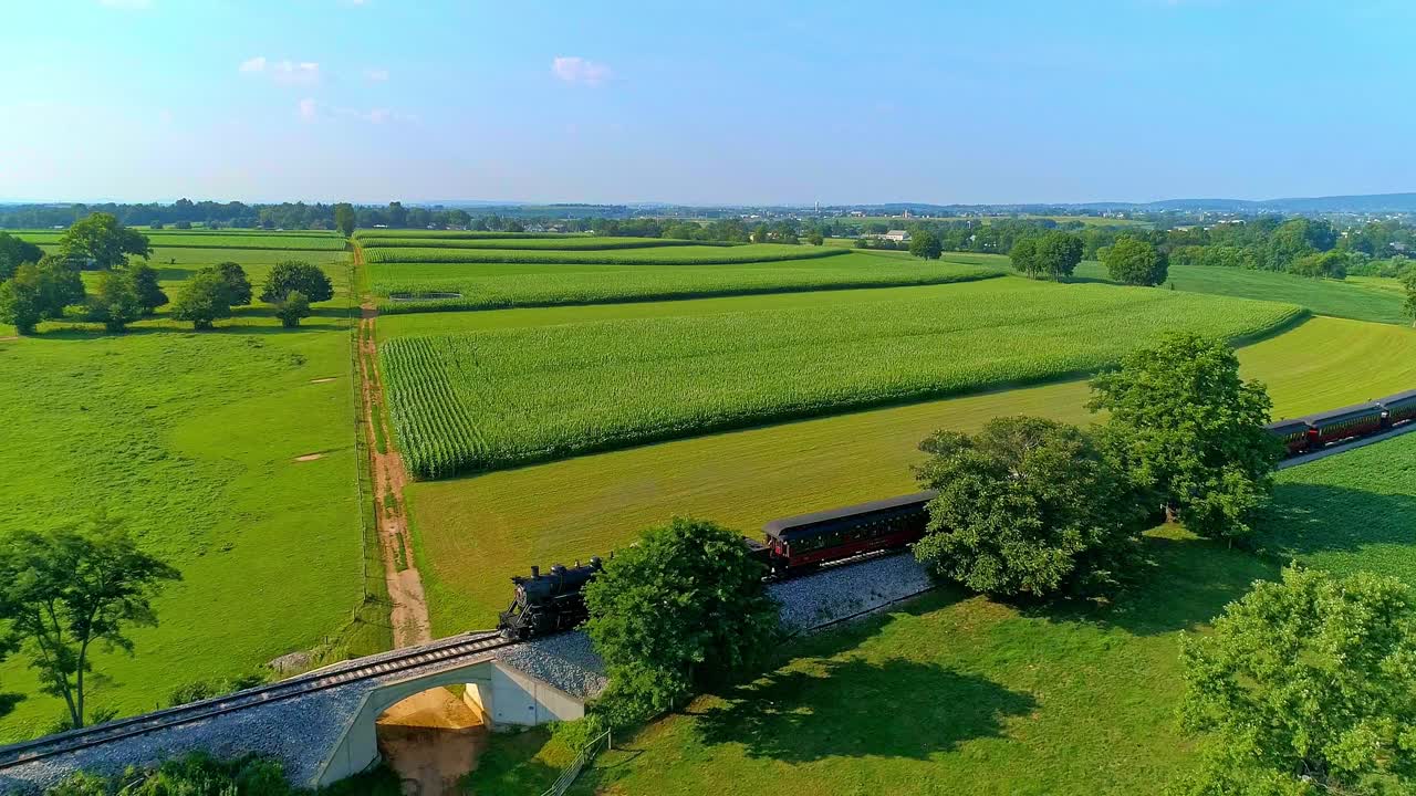 Steam Train Journey Through Lush Green Farmlands
