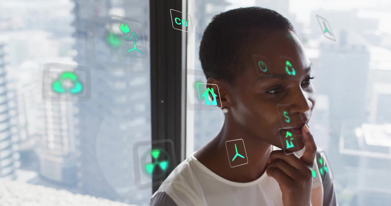 Woman observing holograms appearing and circling in office while analyzing housing and energy cost