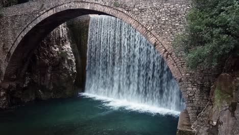 cinematic waterfall. bridge arch. vibrant image