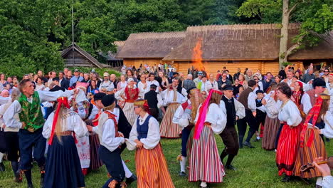 traditional folk dance and bonfire celebration at an outdoor festival