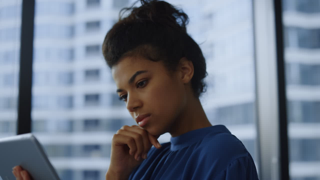 Woman typing on digital tablet
