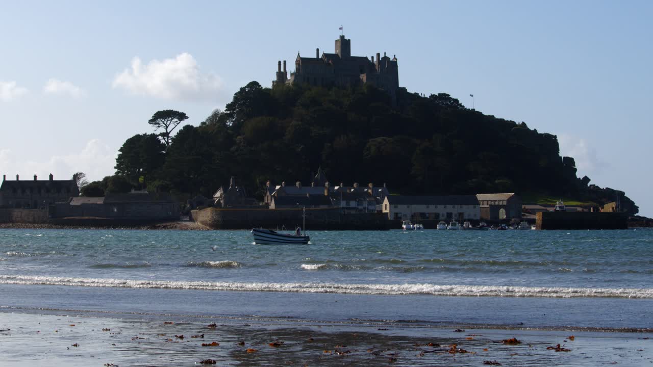 wide shot of Sir Michael's mount silhouetted in the sun taken from Marazion beach