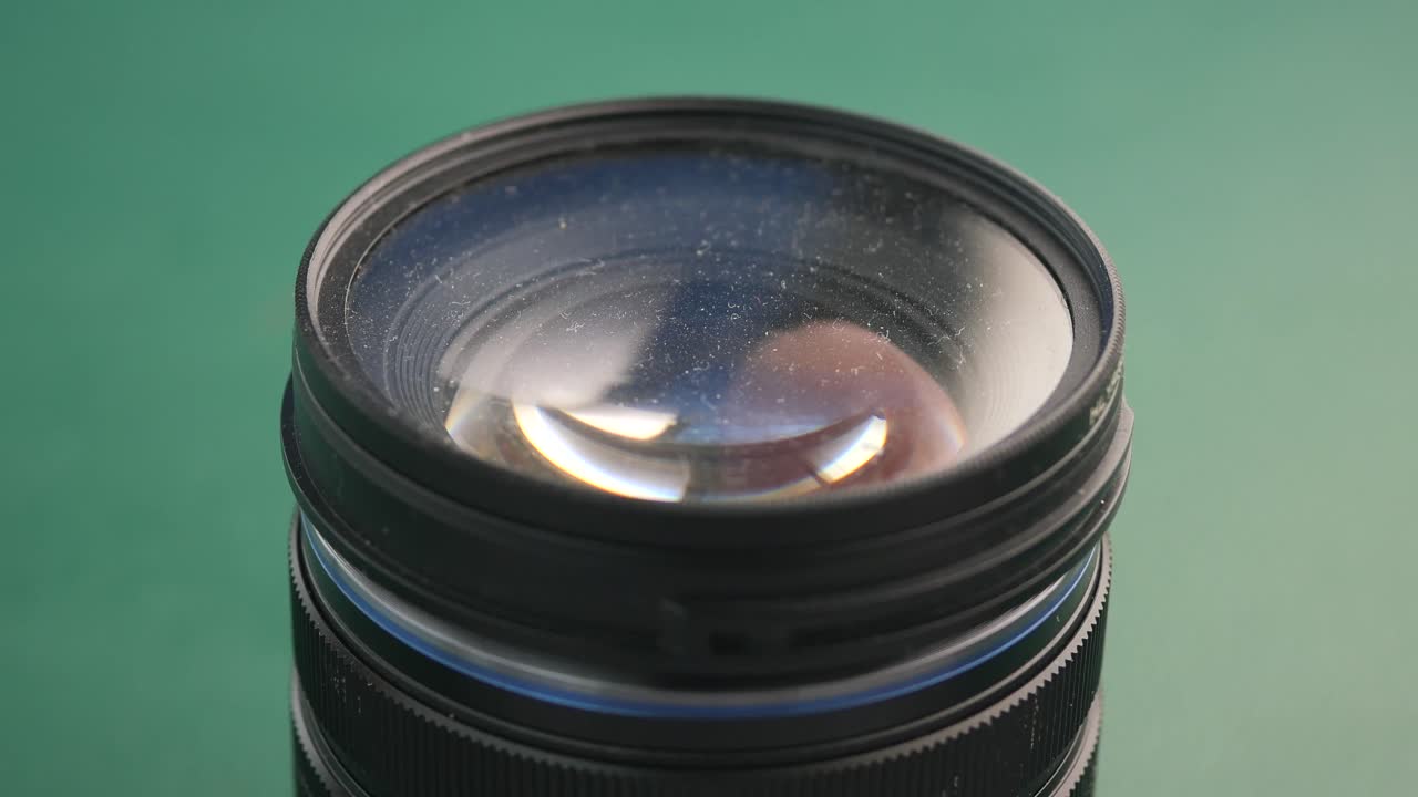 Hand Cleaning a Camera Lens with a Microfiber Cloth